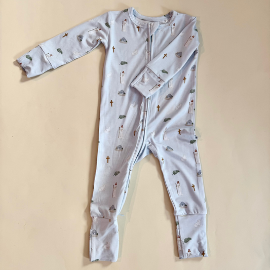 Baby onesie with Easter pattern on a beige background