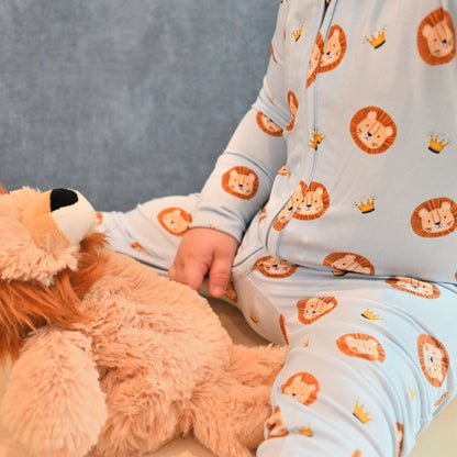 baby wearing lion pattern zip romper with stuffed lion