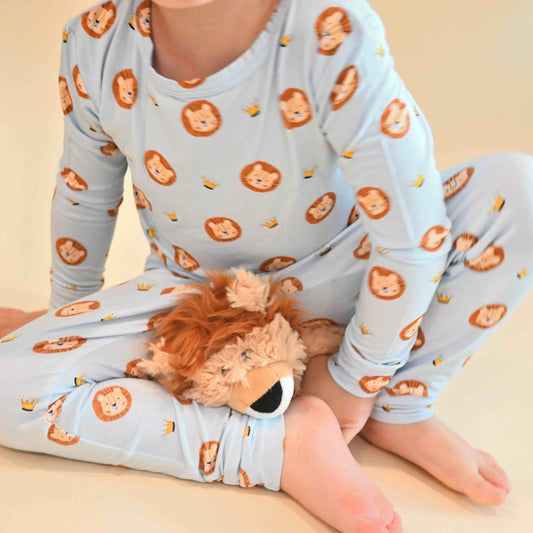 toddler wearing lion print pajamas from neck down