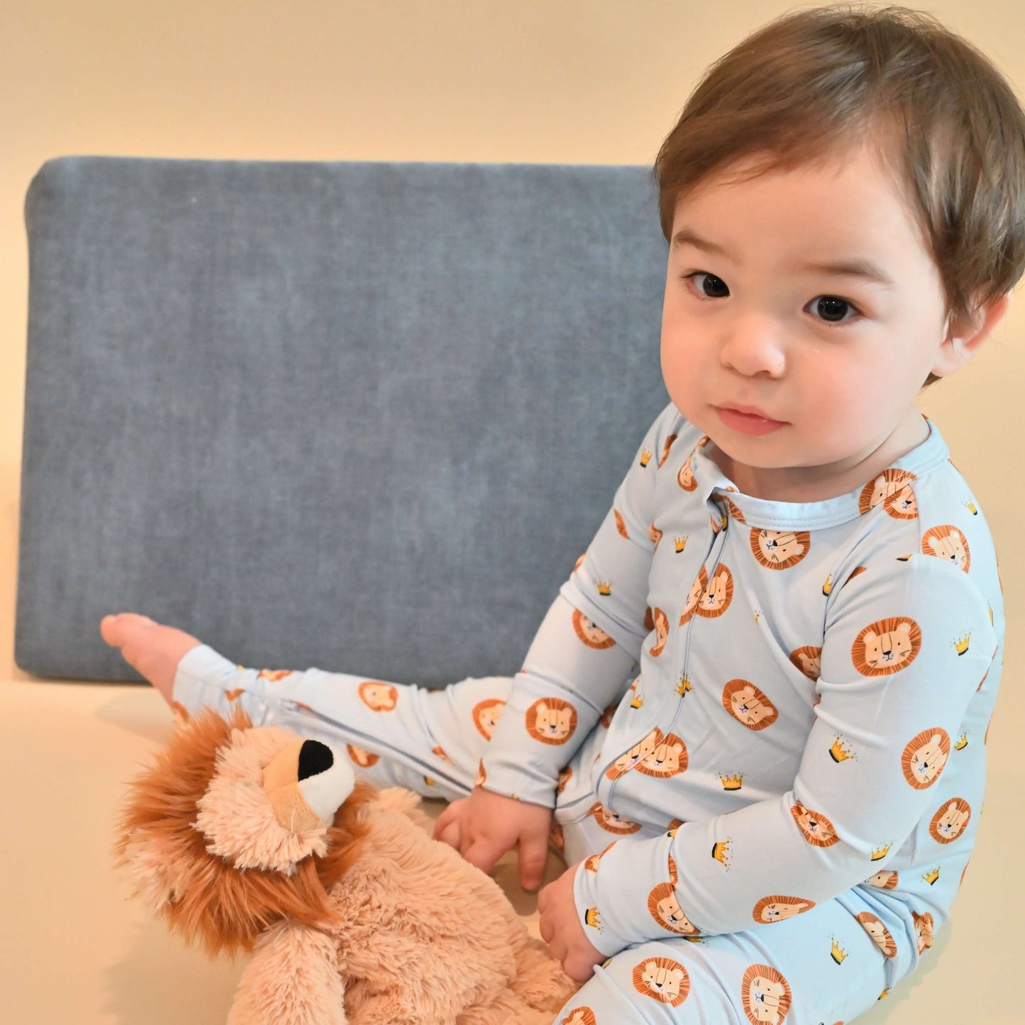 baby boy wearing zip romper with lion pattern