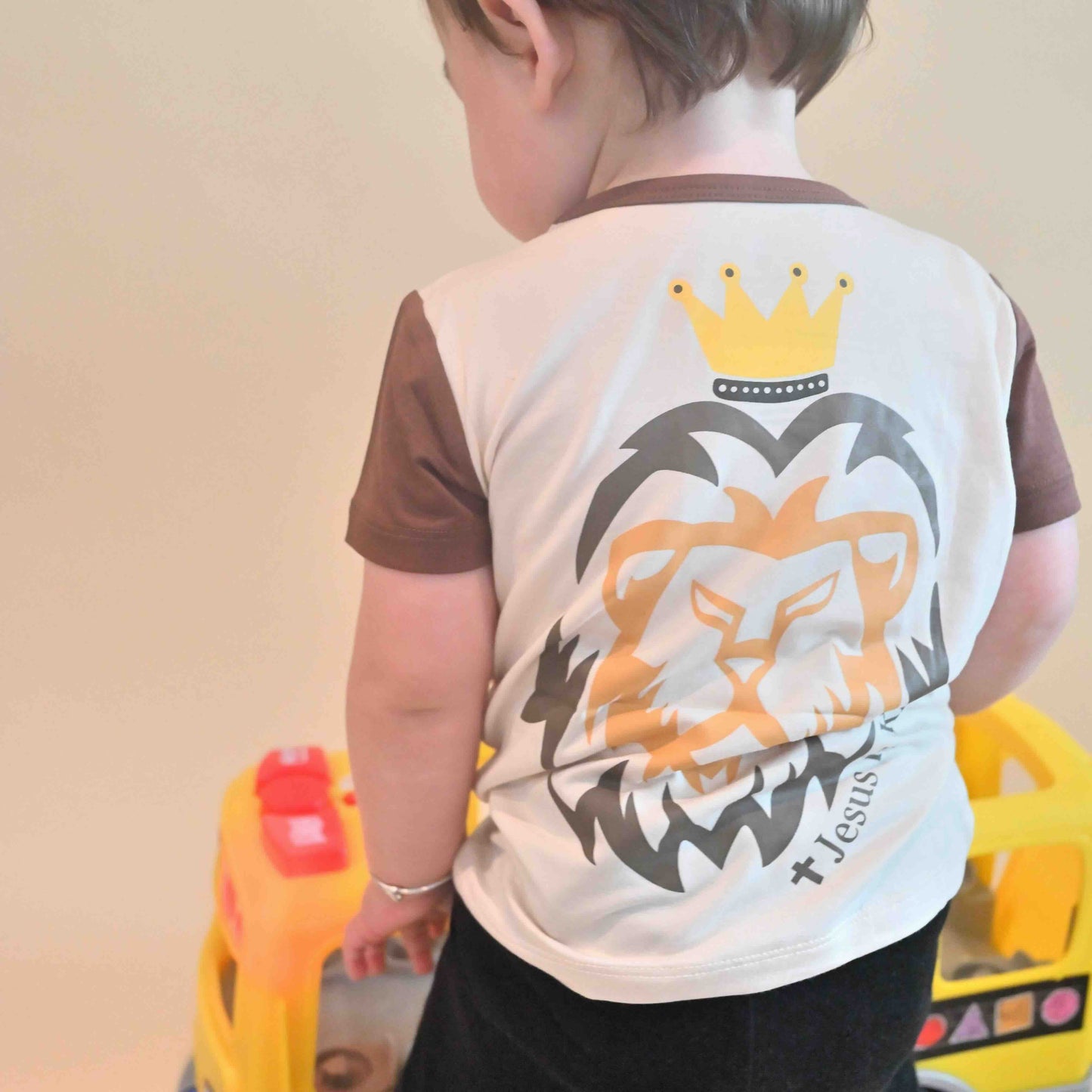 baby boy wearing Jesus is King tee from the back