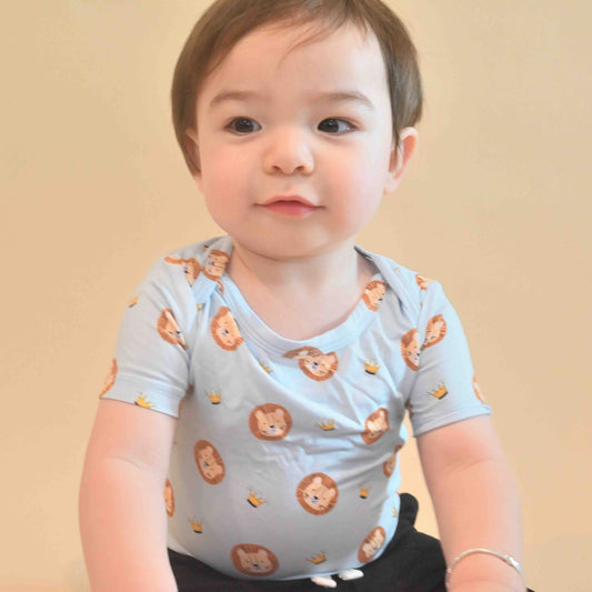baby boy wearing short sleeve onesie with lion and crown pattern