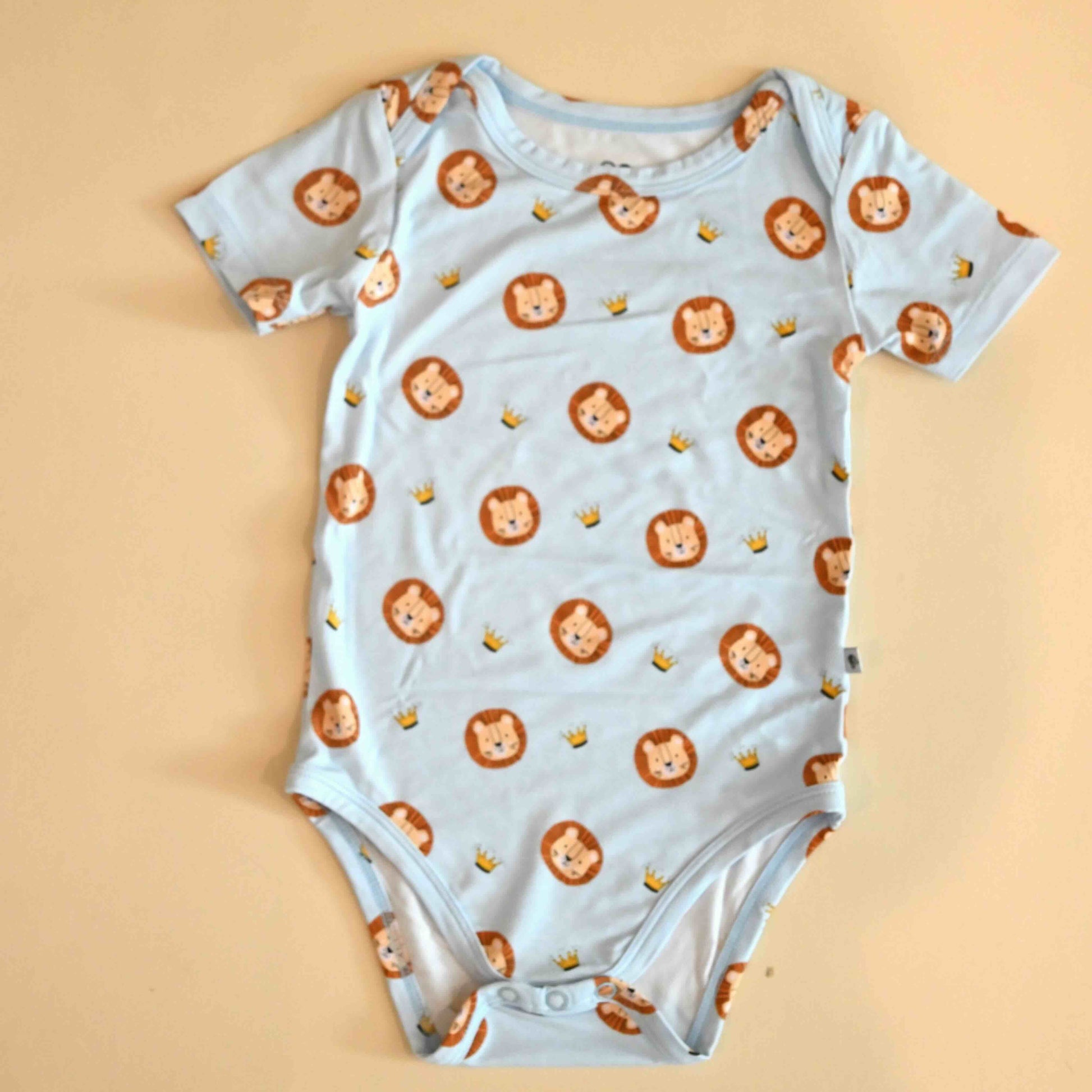 lay flat image of the lion and crown pattern onesie